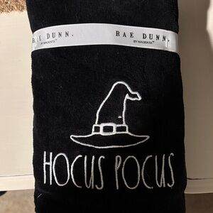 Rae Dunn Black Towel with White Embroidered Witch Hat and 'Hocus Pocus'